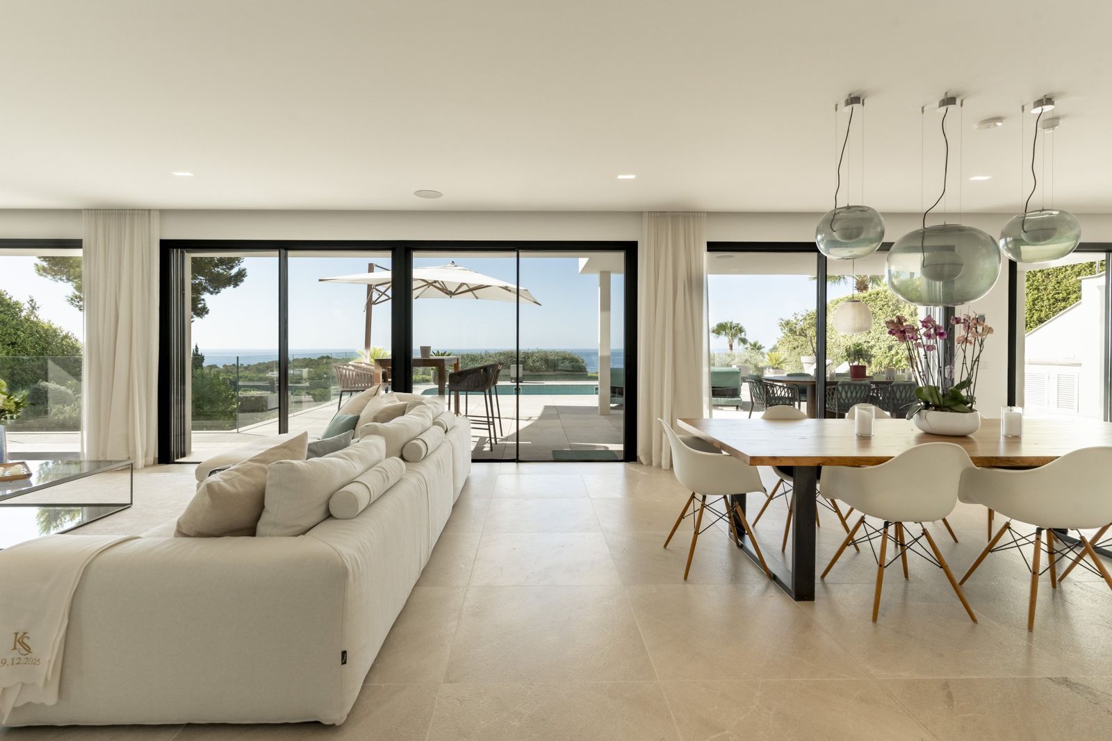 Living and dining room behind floor-to-ceiling glass