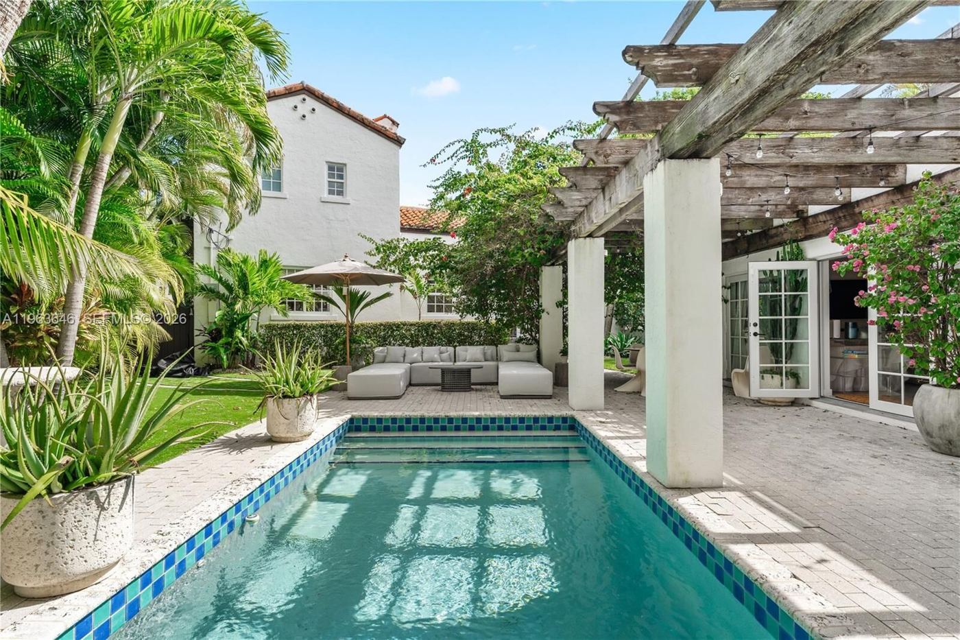 Pool and pergola at a 1926 Mediterranean Revival home in Coral Gables